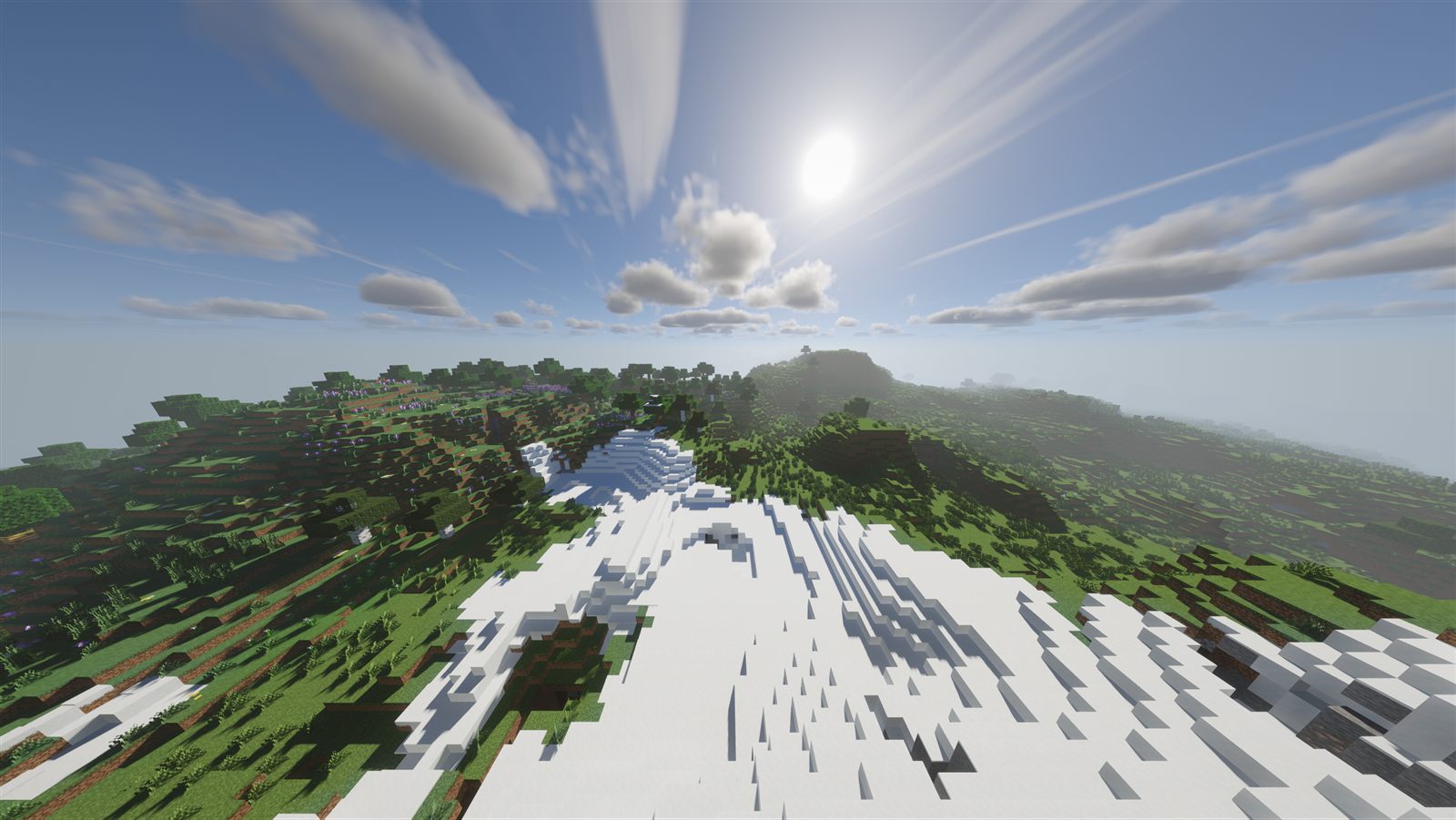 Snowy mountains under a high sun